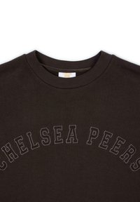 Dark brown sweatshirt featuring "CHELSEA PEERS" embroidered in a curved pattern. Ribbed crew neckline, soft texture, and casual design.