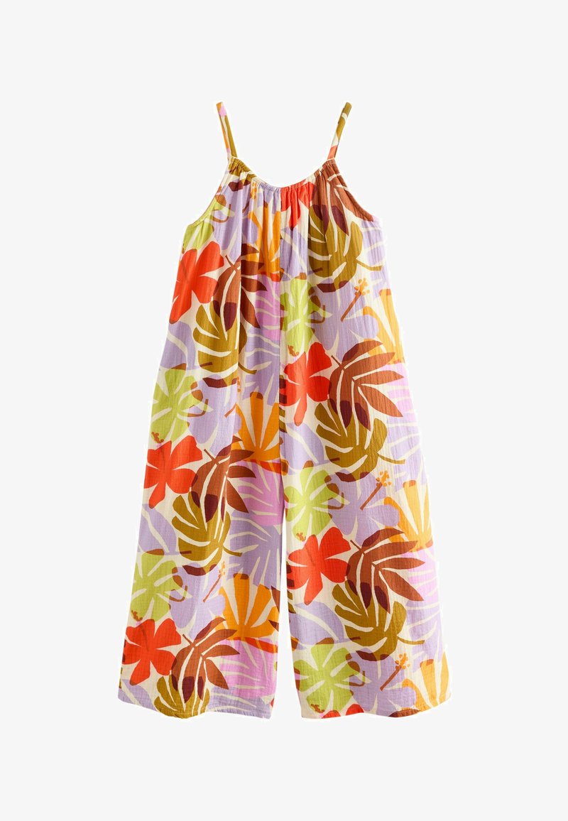 Bezrekawny kombinezon z szerokimi nogawkami na cienkich ramiączkach, ozdobiony kolorowym tropikalnym wzorem liści i kwiatów w odcieniach pomarańczu, zieleni, brązu i fioletu.