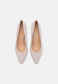 Light pink suede pointed-toe flats with a smooth insole and a low-cut design featuring subtle branding on the interior.