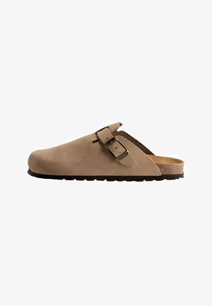 Brown suede clog with a single strap and metal buckle. Features a cork footbed and a textured rubber sole for grip.