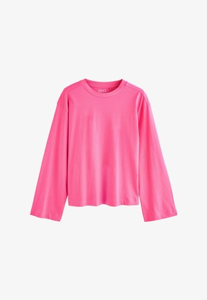 Långärmad rosa T-shirt i mjuk bomull. Har rund halsringning och en avslappnad passform med raglanärmar. Enkel, enfärgad design.