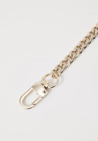 Gold-toned metal chain with interlocking links, featuring a clip closure and a circular attachment ring. Smooth texture, shiny finish.