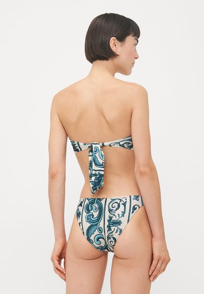 Bikini in blue and cream with a floral pattern; bandeau top with a tied back and matching high-waisted bottoms. Smooth fabric texture.