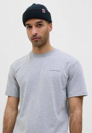 Gray cotton t-shirt with short sleeves and a crew neckline. Features a black text logo on the left chest. Worn with a dark ribbed beanie.