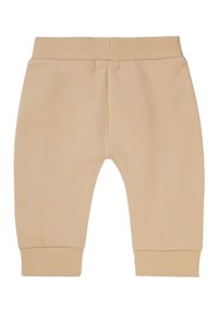 Lichtbeige trainingsbroek met een geribbelde tailleband en boorden. Zacht materiaal, taps toelopend ontwerp en geen zichtbare patronen of logo's.