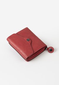 Red leather wallet with a snap closure, zippered edges, and a matching round zipper pull, featuring a smooth texture and compact design.
