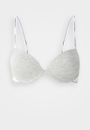 Grauer gepolsterter BH aus glattem Stoff, mit runden Cups, verstellbaren Trägern mit weißem Calvin Klein-Branding und einem nahtlosen Design.