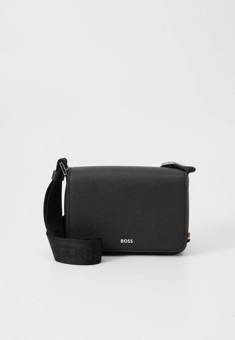 Black crossbody bag made of textured material, featuring a logo on the front, adjustable strap, and rectangular shape.