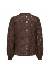 Blusa marrone ricamata con intagli floreali, maniche a sbuffo e polsini con bottoni, realizzata in tessuto leggero con superficie testurizzata.