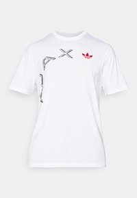 White cotton t-shirt featuring black graphic designs and a red Adidas trefoil logo on the upper left side. Crew neckline and short sleeves.