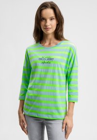 Green and blue striped long-sleeve shirt with a round neckline and printed text on the chest. Soft, lightweight fabric.