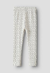 Bílé žebrované legíny s černými puntíky, s elastickým pasem. Navrženy pro pohodlí a flexibilitu, vhodné pro každodenní nošení.