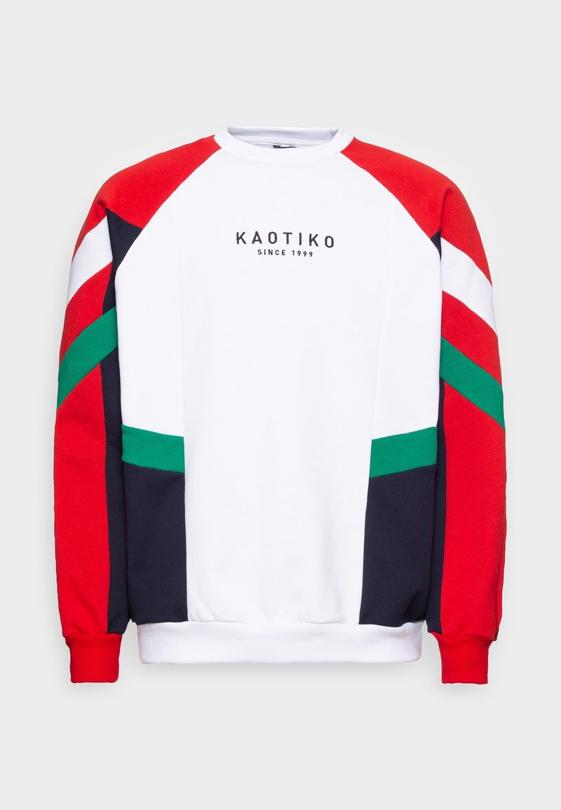 Sweat-shirt blanc avec manches color-block rouges, vertes, noires et blanches, avec l'inscription « KAOTIKO SINCE 1999 » imprimée en noir sur la poitrine.