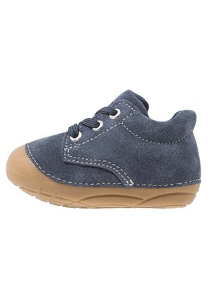 Blue suede toddler shoe with tan rubber sole and laces, side view, highlighting stitching and texture on white background.