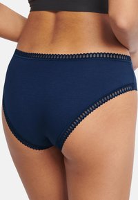 Navy blue cotton panties with a scalloped lace trim at the waistband and leg openings, featuring a smooth texture and full coverage design.