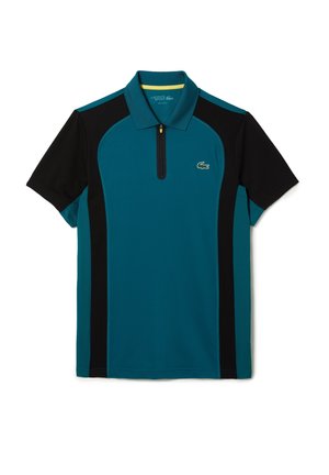 Polo manches courtes bleu sarcelle et noir avec col zippé et petit logo crocodile vert sur la poitrine.