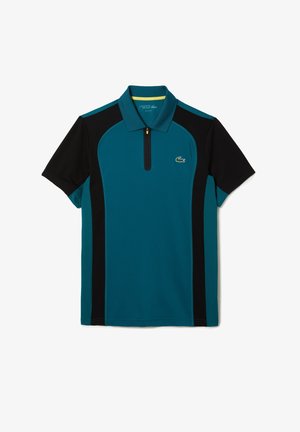 Polo manches courtes bleu sarcelle et noir avec col zippé et petit logo crocodile vert sur la poitrine.