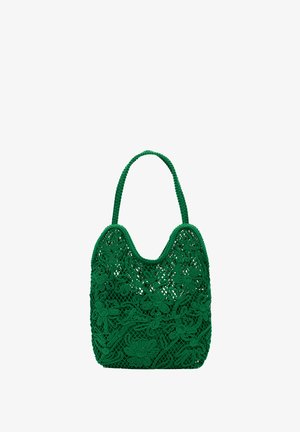Sac à main au crochet vert présentant un design floral, une forme arrondie et une surface texturée, avec deux poignées.