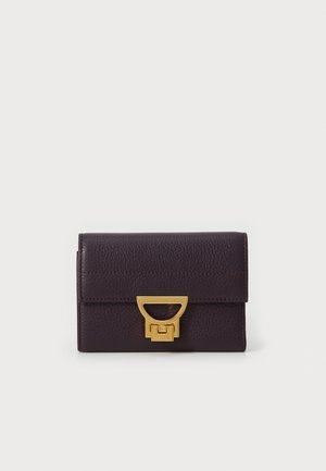 Purple leather wallet with a textured finish, featuring a gold-toned clasp and subtle stitching details on the front. Compact rectangular shape.