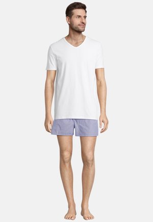 White v-neck t-shirt and blue striped shorts. T-shirt is soft fabric, shorts are lightweight with an elastic waistband. Barefoot.