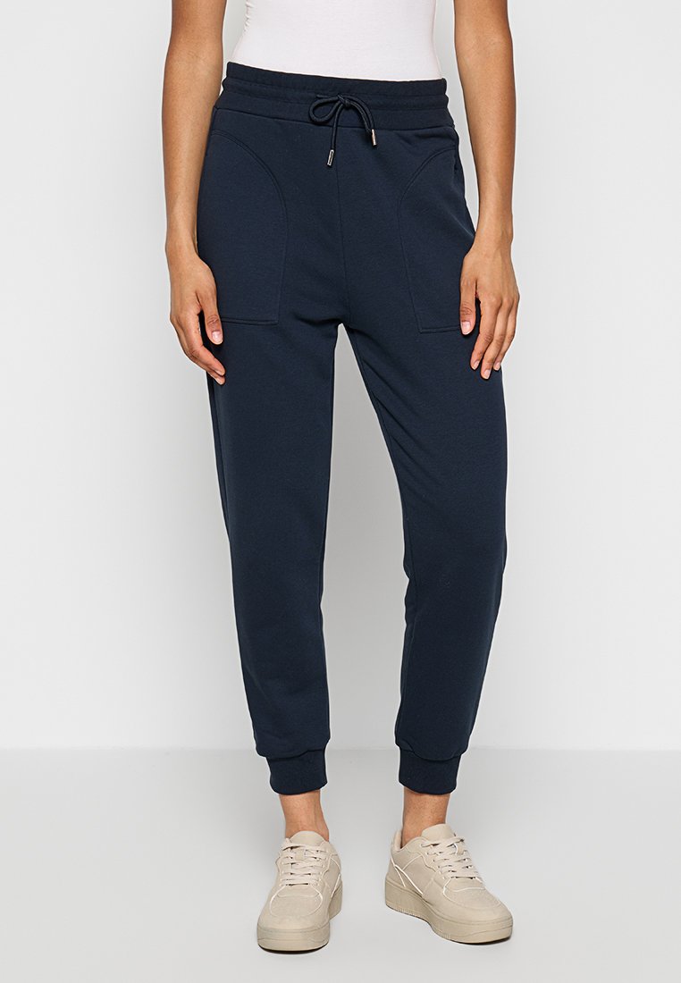 Marineblaue Jogginghosen aus weichem Stoff, mit einem elastischen Bund und Kordelzug, seitlichen Taschen und gerippten Bündchen.