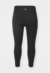 Sorte atletiske leggings med høj talje, lavet af strækbart materiale. Har en diskret logo på bagsiden og et rent, sømløst design.