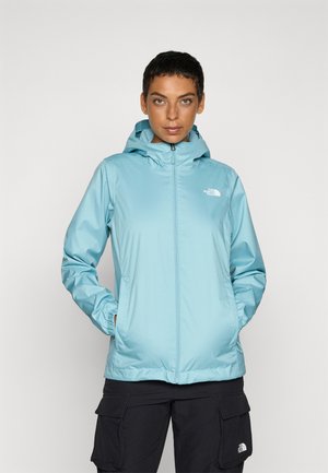 Veste bleu clair, résistante à l'eau, avec capuche, fermeture éclair intégrale, poignets élastiques et logo brodé sur la poitrine gauche. Texture douce.