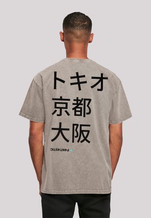 Gray oversized t-shirt featuring large black Japanese text on the back. Soft cotton fabric with a slightly distressed finish.
