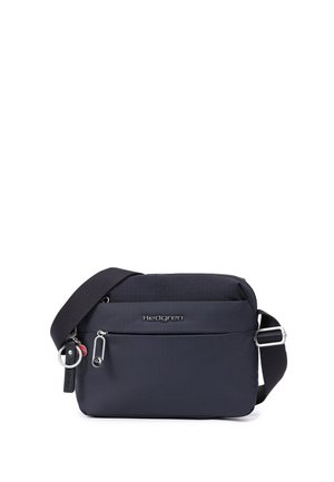 Sac bandoulière compact bleu foncé avec sangle noire réglable, poche avant zippée et logo Hedgren sur le panneau avant.