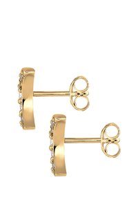 Orecchini a stud in tono oro con un design curvo e piccoli cristalli trasparenti rotondi lungo un lato. Chiusura con farfallina.