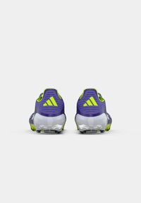 Purple cleats with green accents, textured upper material, and a molded outsole. Features two rear tabs and notable three-stripe logo.