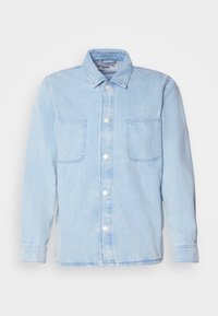 Light blue denim shirt with long sleeves, button-up front, two chest pockets, and a classic collar. Made from soft, textured fabric.
