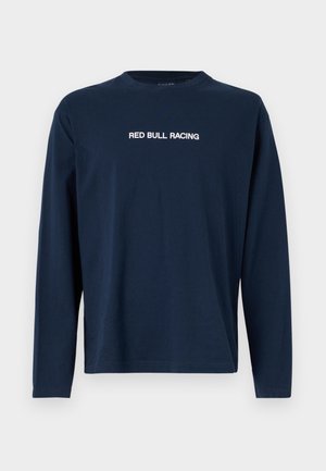 Tumed pikkade varrukatega T-särk, mis on valmistatud puuvillast, ümmarguse kaeluse ja valge tekstiga "RED BULL RACING" rinna peal.