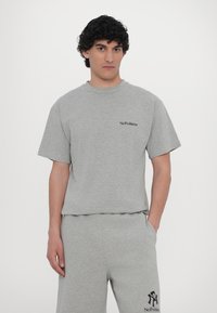 Gray cotton t-shirt with a crew neckline and short sleeves featuring "No Problemo" in black text on the left chest. Casual fit.