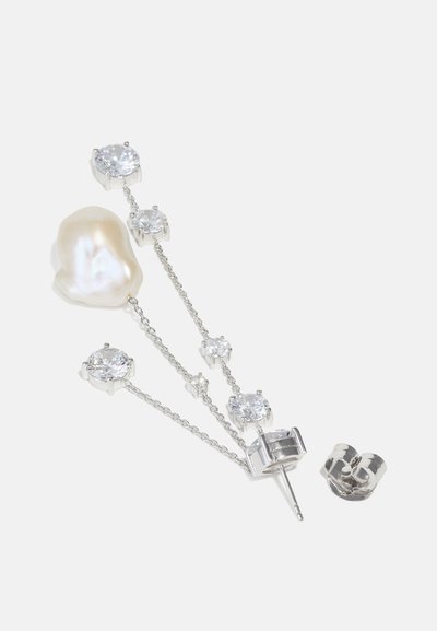 Σκουλαρίκια με ασημένιες αλυσίδες, που διαθέτουν μια μεγάλη μπαρόκ πέρλα και πολλαπλές διαφανείς πέτρες σε διάφορα μεγέθη. Περιλαμβάνουν κλιπ κλεισίματος.