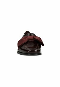 Dark brown glossy loafer with a large fabric bow on top, viewed from the front against a white background.