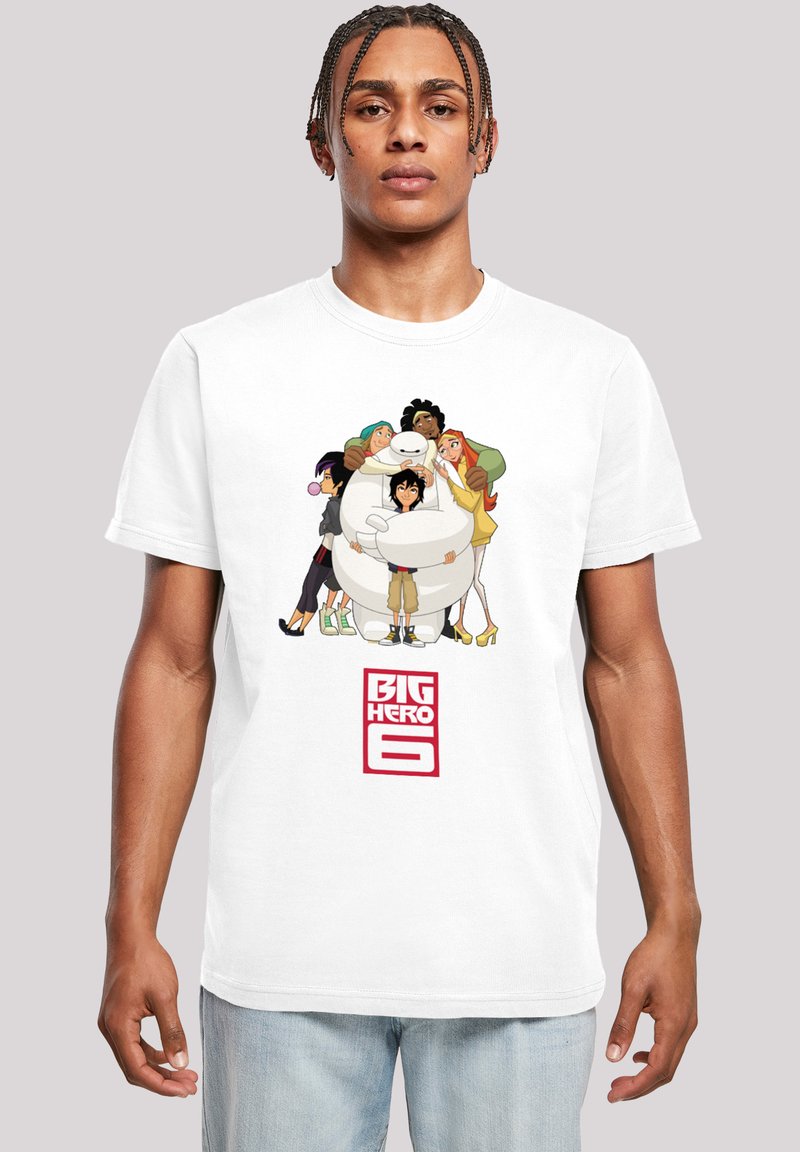 White cotton t-shirt featuring an animated design of characters from "Big Hero 6" with bold red text underneath. Casual fit, short sleeves.