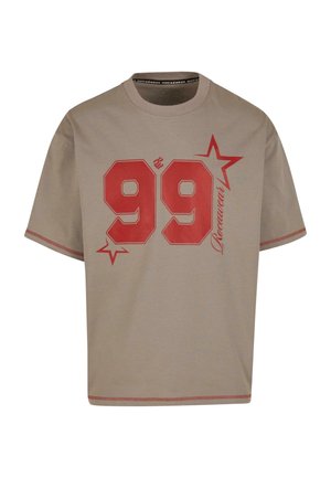 Beige cotton t-shirt with short sleeves, featuring a large red graphic "99" and accent stars. Contrast stitching along the hem.