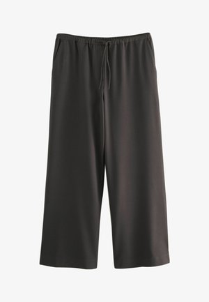 Schwarze, weit geschnittene Hose aus einem glatten Stoff. Sie verfügt über einen elastischen Bund mit verstellbarem Kordelzug und zwei Seitentaschen.