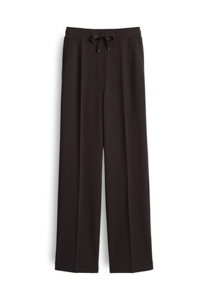Schwarze, weit geschnittene Hosen aus weichem Stoff, mit einem elastischen Bund und Kordelzug sowie seitlichen Taschen für Funktionalität.