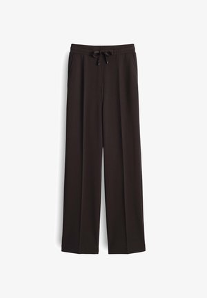 Schwarze, weit geschnittene Hosen aus weichem Stoff, mit einem elastischen Bund und Kordelzug sowie seitlichen Taschen für Funktionalität.