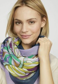 Écharpe multicolore présentant des motifs fluides en vert, violet et bleu, fabriquée en tissu léger avec une texture douce.