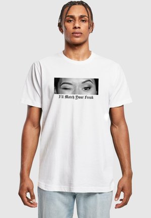 White cotton t-shirt featuring a black and white graphic of a winking eye and the text "I’ll Match Your Freak" in bold font.