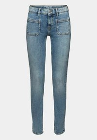Tight jeans tillverkade av blå denim. Har en klassisk femfickorsdesign, synlig sömnad och en märkesetikett i midjan.