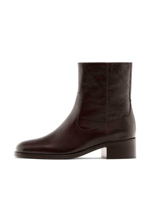 Brown leather ankle boot with a smooth texture, rounded toe, and a low block heel. Side elastic panels for easy wear.