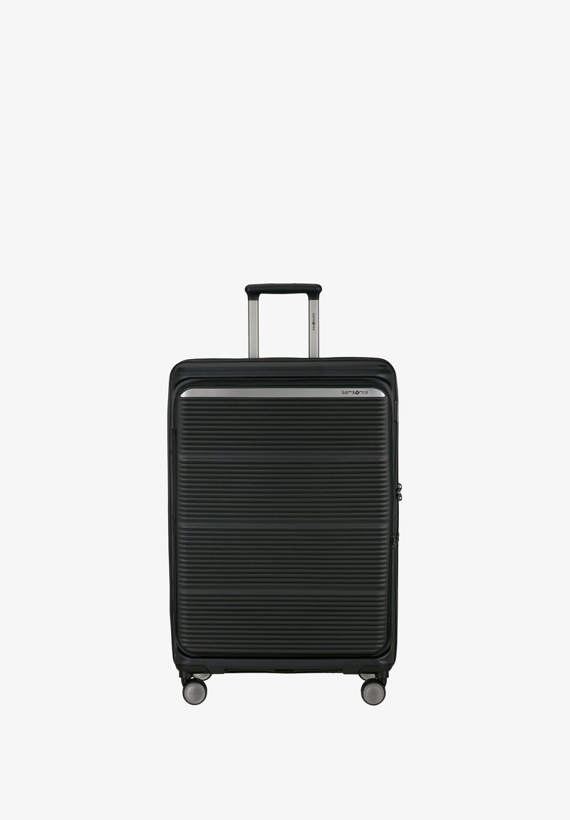 Black hard-shell suitcase with horizontal ridges, four wheels, and a fully extended telescopic handle.