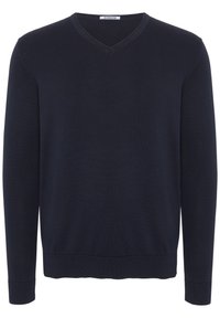 Mörkblå V-ringad tröja i stickad kvalitet. Har långa ärmar samt ribbad nederkant och mudd. Enkelt och klassiskt design.