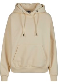 Sweat à capuche de couleur crème en tissu doux, avec une poche avant, des cordons de serrage réglables et des poignets côtelés pour un ajustement confortable.