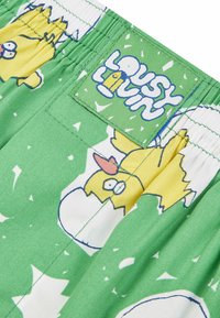 Green shorts with a playful egg and chick print. Features an elastic waistband and a label that reads "LOUSY LOVIN." Soft fabric texture.
