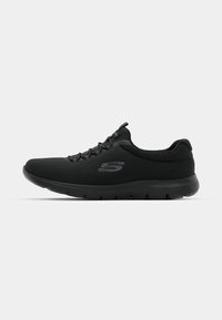 Black athletic shoes with a textured upper, lace closure, and cushioned black sole. Features a subtle logo on the side.